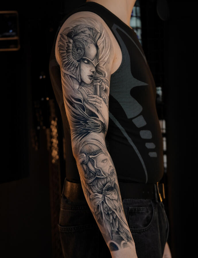 Anime Blackwork Tattoo Anime-inspired tattoo featuring a Rize from Tokyo Ghoul, black and grey shading, and red accents on the arm, by Myst Tattoo Studio in Tbilisi, Georgia.